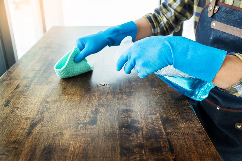 man cleaning table